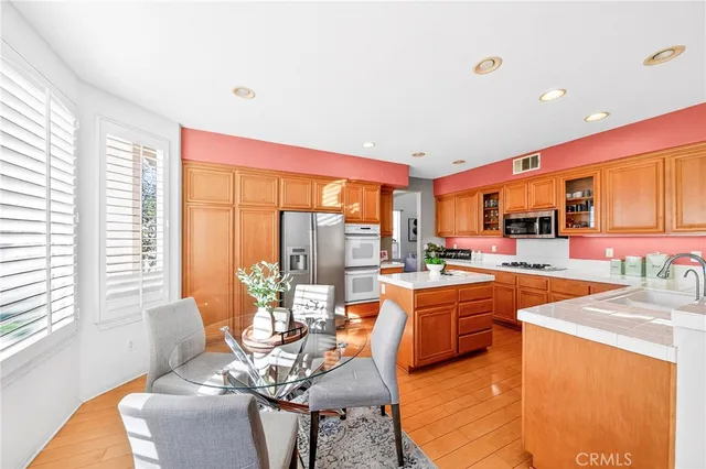 a living room with furniture a fireplace and a potted plant