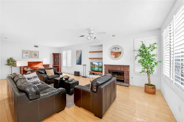 a living room with furniture a fireplace and a wooden floor