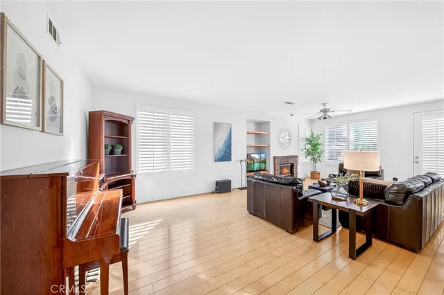 a living room with furniture a piano and a bookshelf