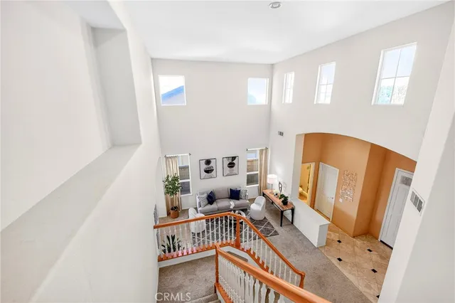 a bedroom with a bed table flowerpot and window
