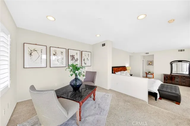 a bedroom with a large bed and a painting on the wall