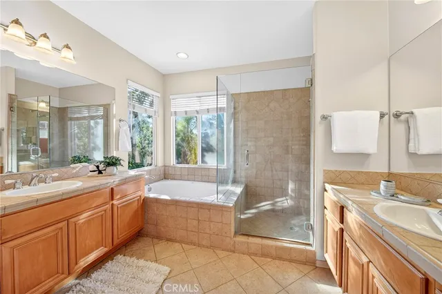 a bathroom with a double vanity sink and a mirror