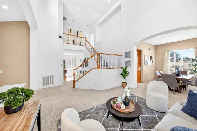 a living room with furniture and stairs