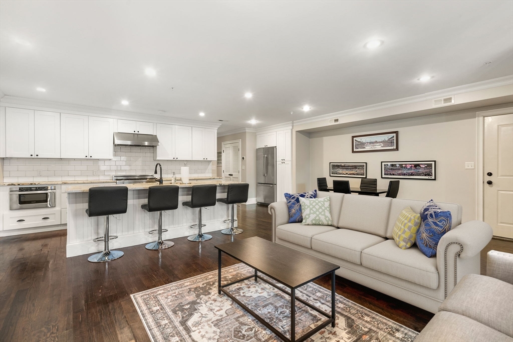 a living room with furniture and kitchen view