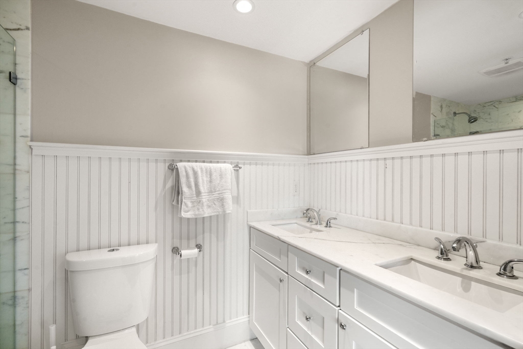215 Athens Street, Unit 4 Boston, MA 02127 - Photo 12 of 19 a bathroom with a granite countertop sink and a mirror