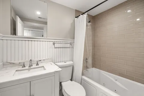 a bathroom with a sink toilet and shower