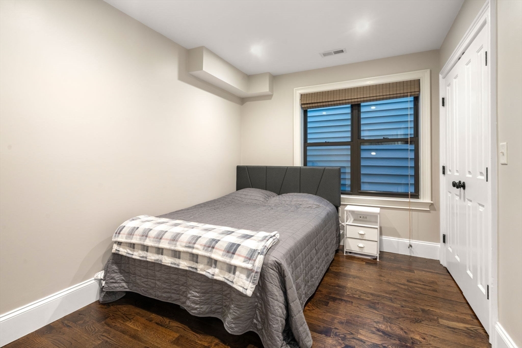 215 Athens Street, Unit 4 Boston, MA 02127 - Photo 15 of 19 a bedroom with a bed and a window