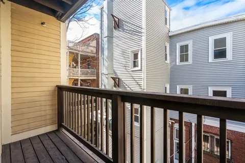 a view of a balcony with wooden floor