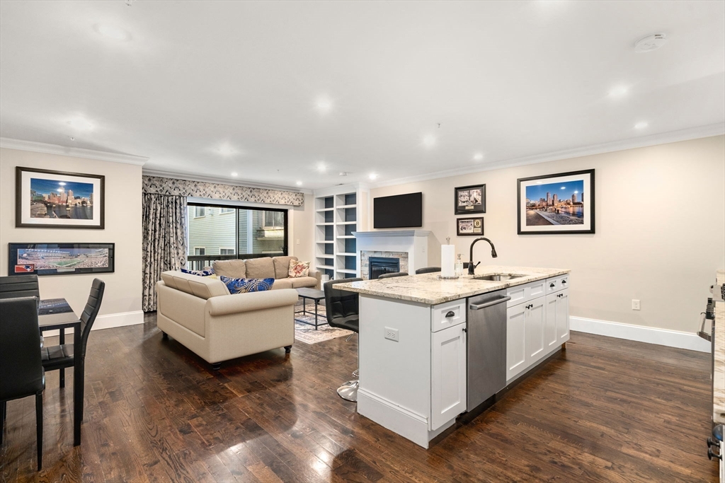 215 Athens Street, Unit 4 Boston, MA 02127 - Photo 4 of 19 a view of living room with kitchen island furniture and flat screen tv