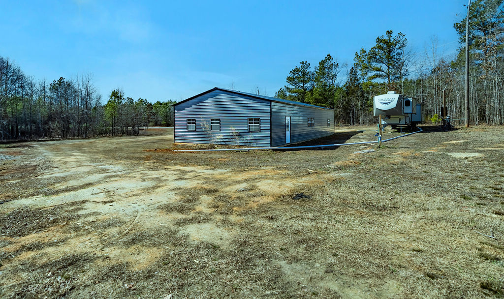 900 Asaville School Road Anderson, SC 29621 - Photo 6 of 29 This metal outbuilding offers versatile space with surrounding natural beauty.