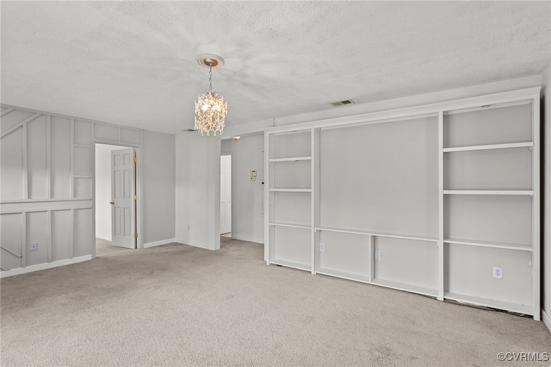 11021 Cosby Mill Road Quinton, VA 23141 - Photo 12 of 43 Empty room featuring a textured ceiling, light car