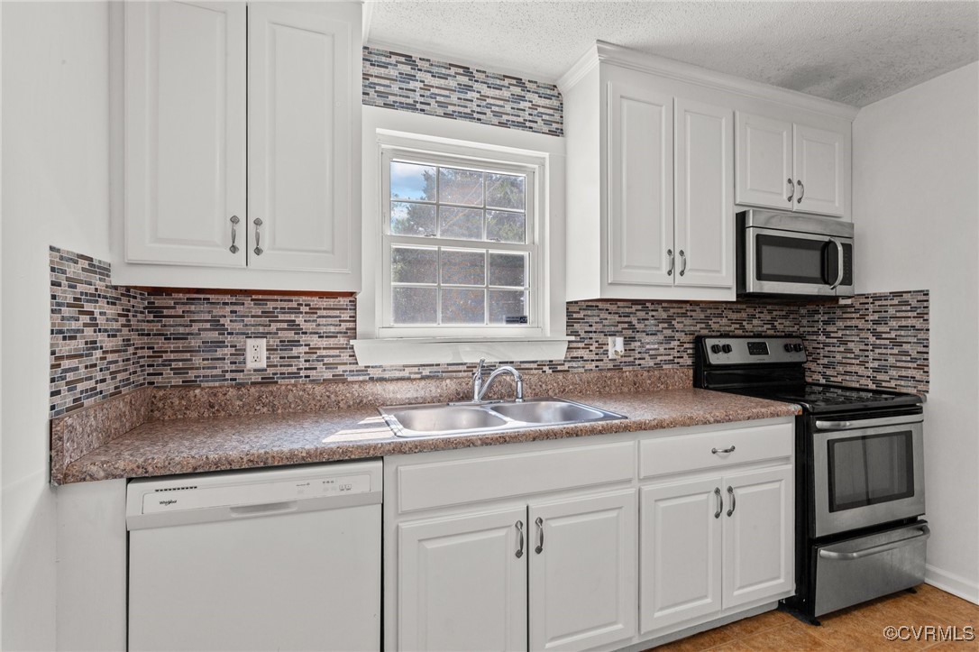 11021 Cosby Mill Road Quinton, VA 23141 - Photo 14 of 43 Kitchen with white cabinets, sink, stainless steel