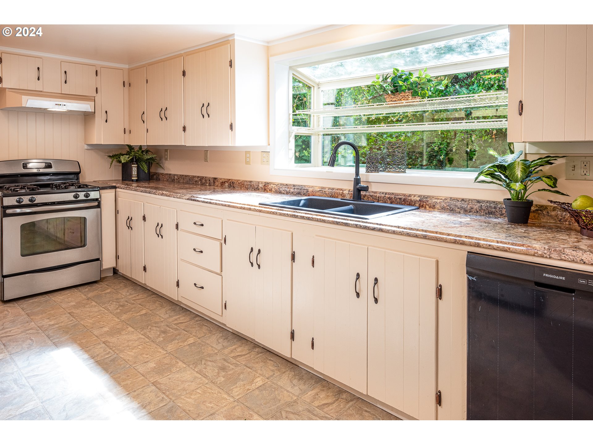 2875 Adams Street Eugene, OR 97405 - Photo 14 of 47 a kitchen with stainless steel appliances granite countertop a sink a stove and cabinets