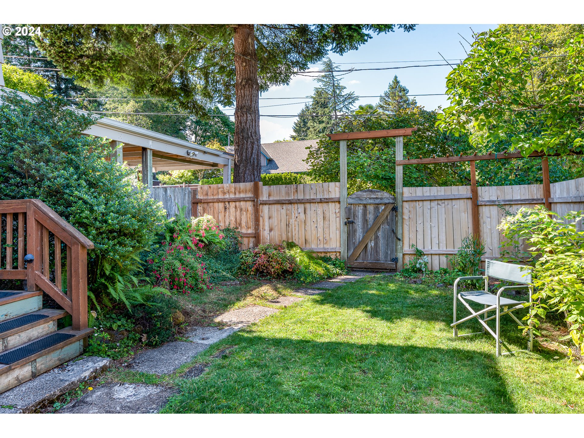 2875 Adams Street Eugene, OR 97405 - Photo 30 of 47 a view of a backyard with table and chairs and wooden fence