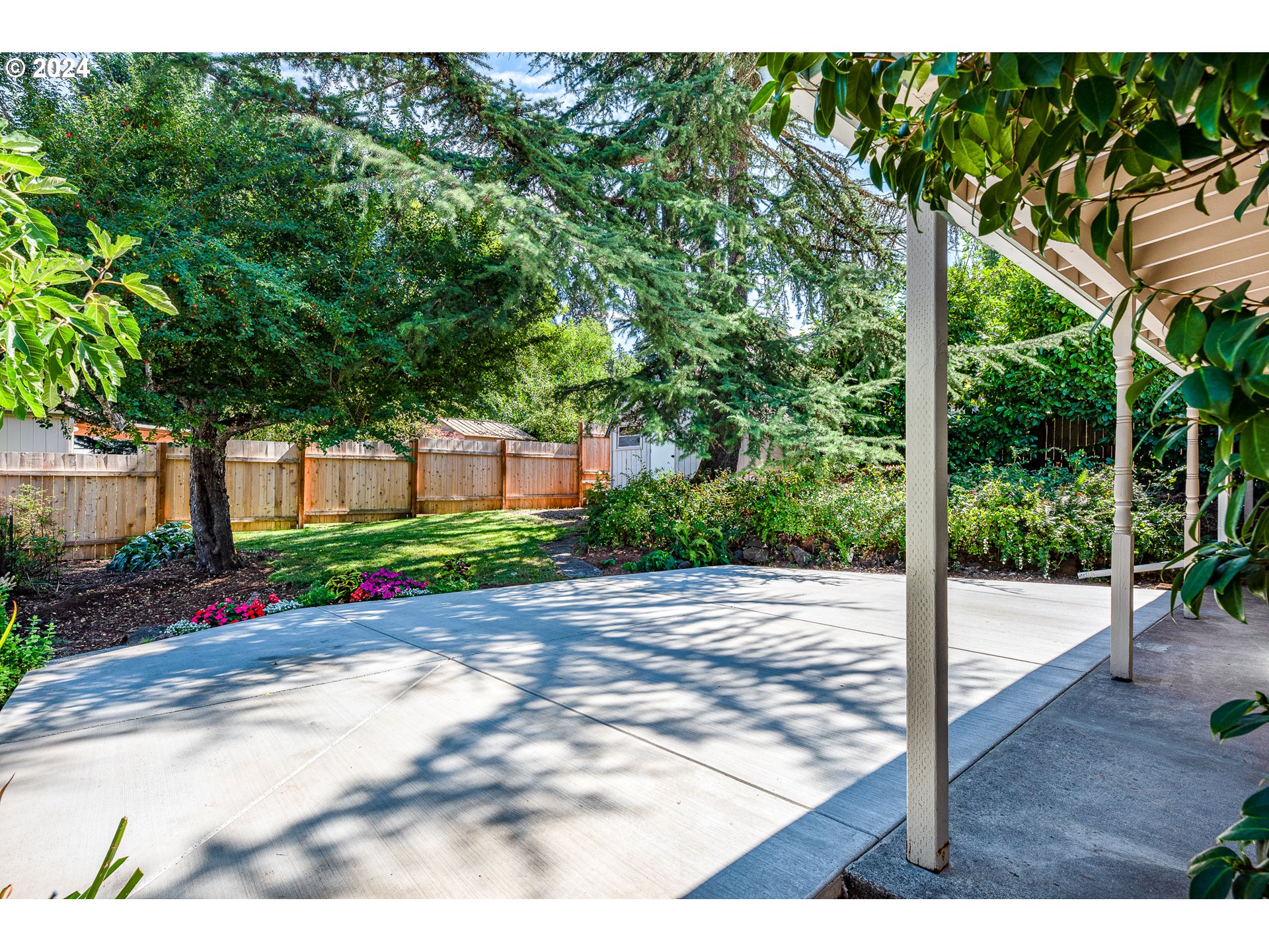 2875 Adams Street Eugene, OR 97405 - Photo 38 of 47 a view of a patio with table and chairs plants and large trees