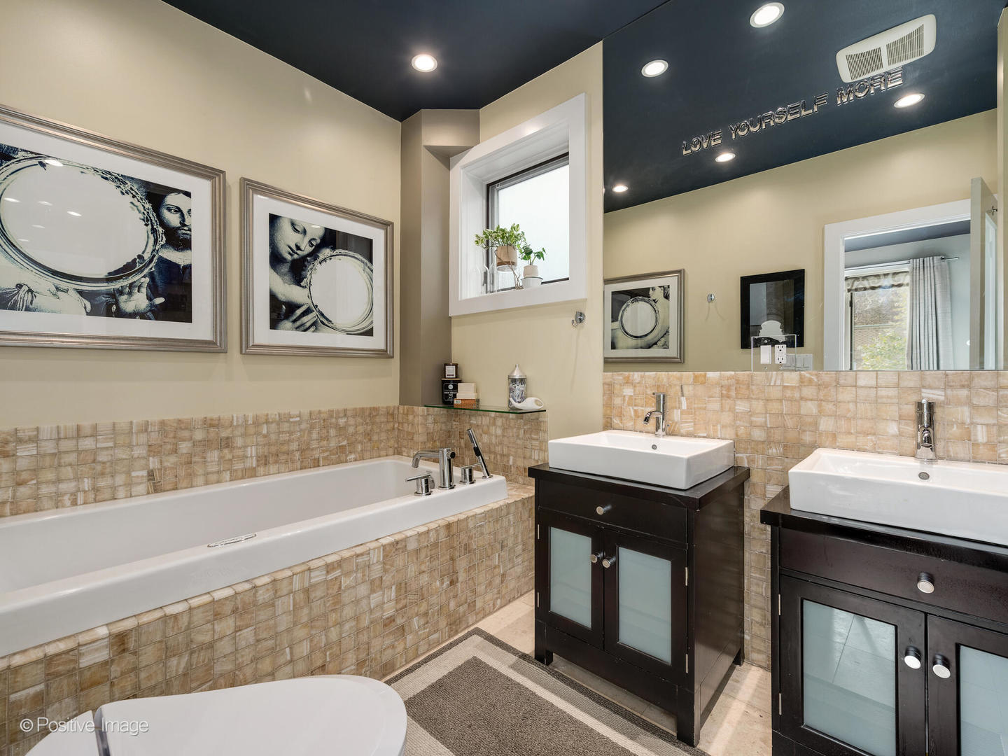 1934 West Armitage Avenue, Unit 2 Chicago, IL 60622 - Photo 18 of 33 a bathroom with a double vanity sink a mirror and a bathtub