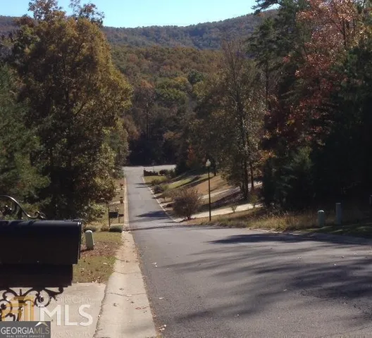 a view of a mountain range with trees in the background