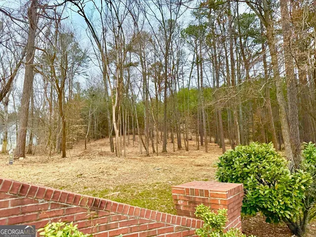 a swimming pool with trees in the background