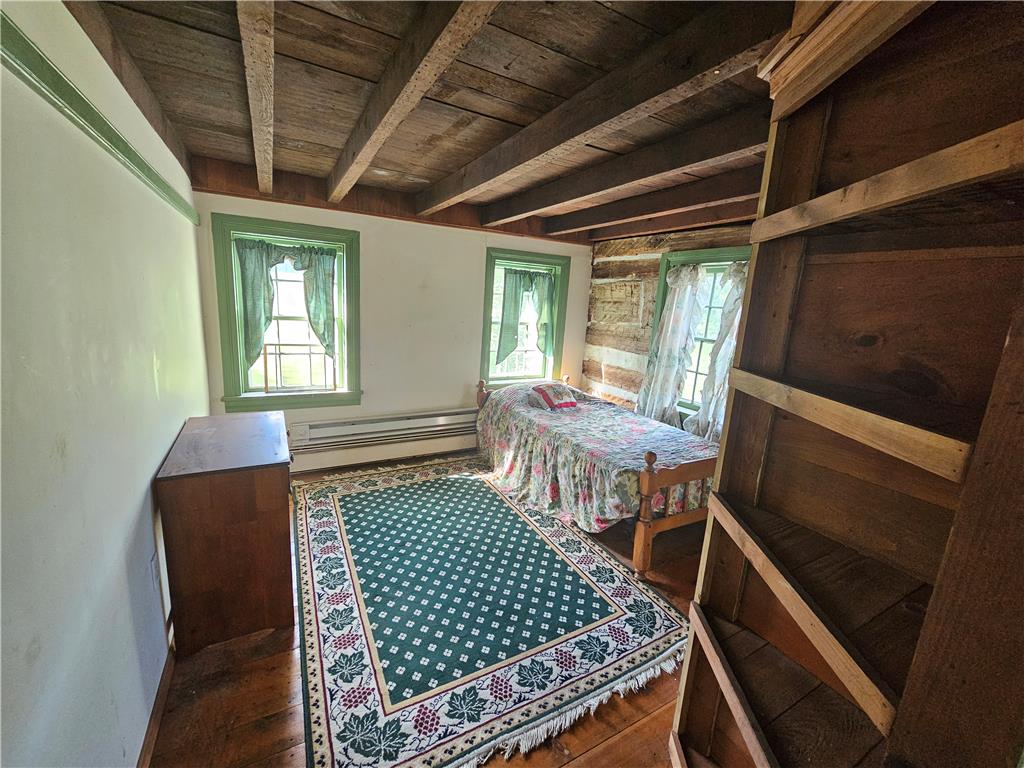 9128 Slateville Road Kempton, PA 19529 - Photo 9 of 13 Exposed wood beam ceilings and wood plank flooring offer rustic charm.