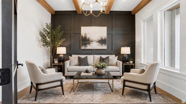 1682 North 1950 W Street, Unit 9 Provo, UT 84604 - Photo 82 of 84 Living area featuring a paneled accent wall, exposed wood-finish ceiling beams, and a brass chandelier