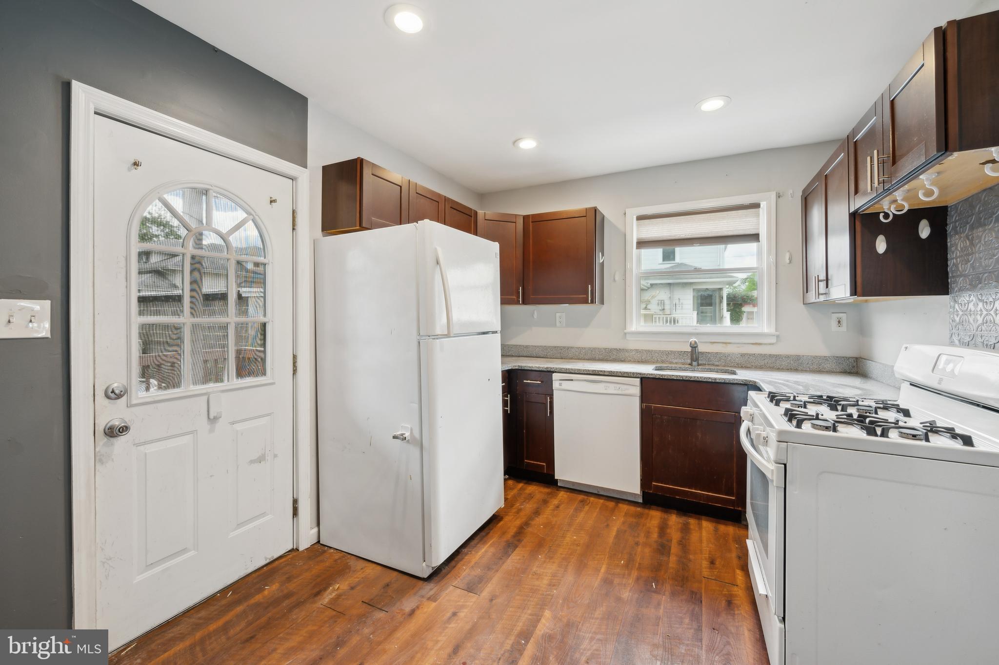 36 Lee Street Riverside, NJ 08075 - Photo 16 of 21 a kitchen with a refrigerator a stove top oven a sink and wooden floor