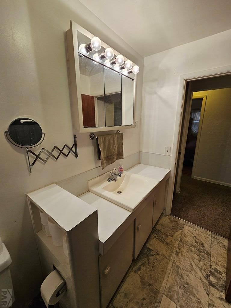 900 Rittgers Street Eads, CO 81036 - Photo 14 of 31 a bathroom with a double vanity sink and a mirror