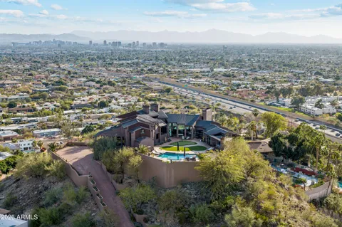 an aerial view of residential houses with outdoor space and trees