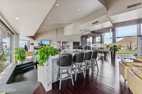 a living room with furniture and large windows