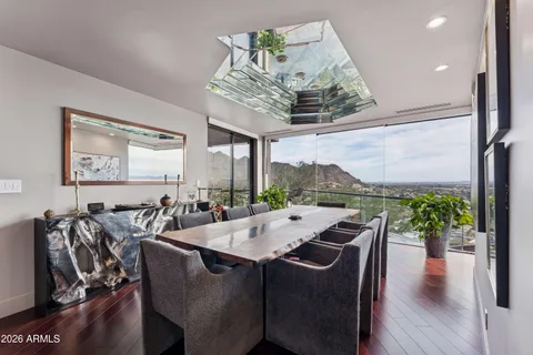 a large kitchen with stainless steel appliances a sink stove and cabinets