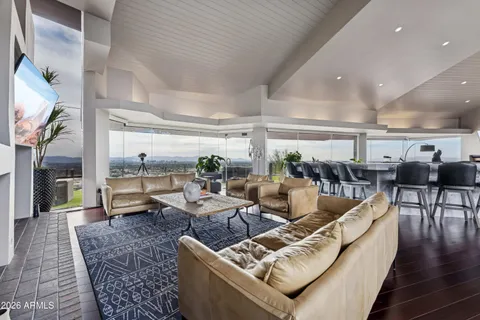 a living room with lots of furniture and a table
