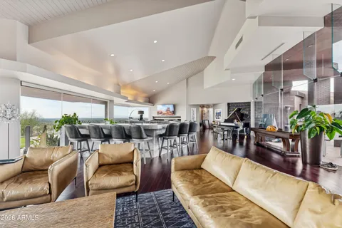 a living room with patio furniture and a floor to ceiling window