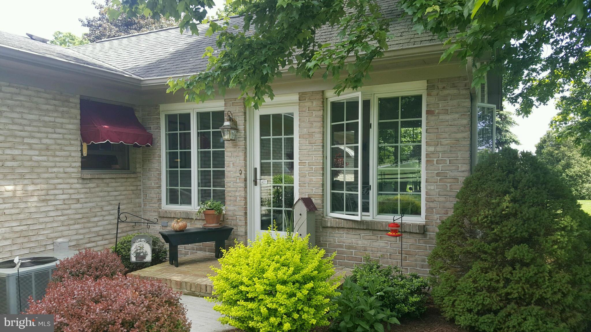 13026 Blairs Valley Road Clear Spring, MD 21722 - Photo 4 of 30 a view of a brick house with a large window and potted plants