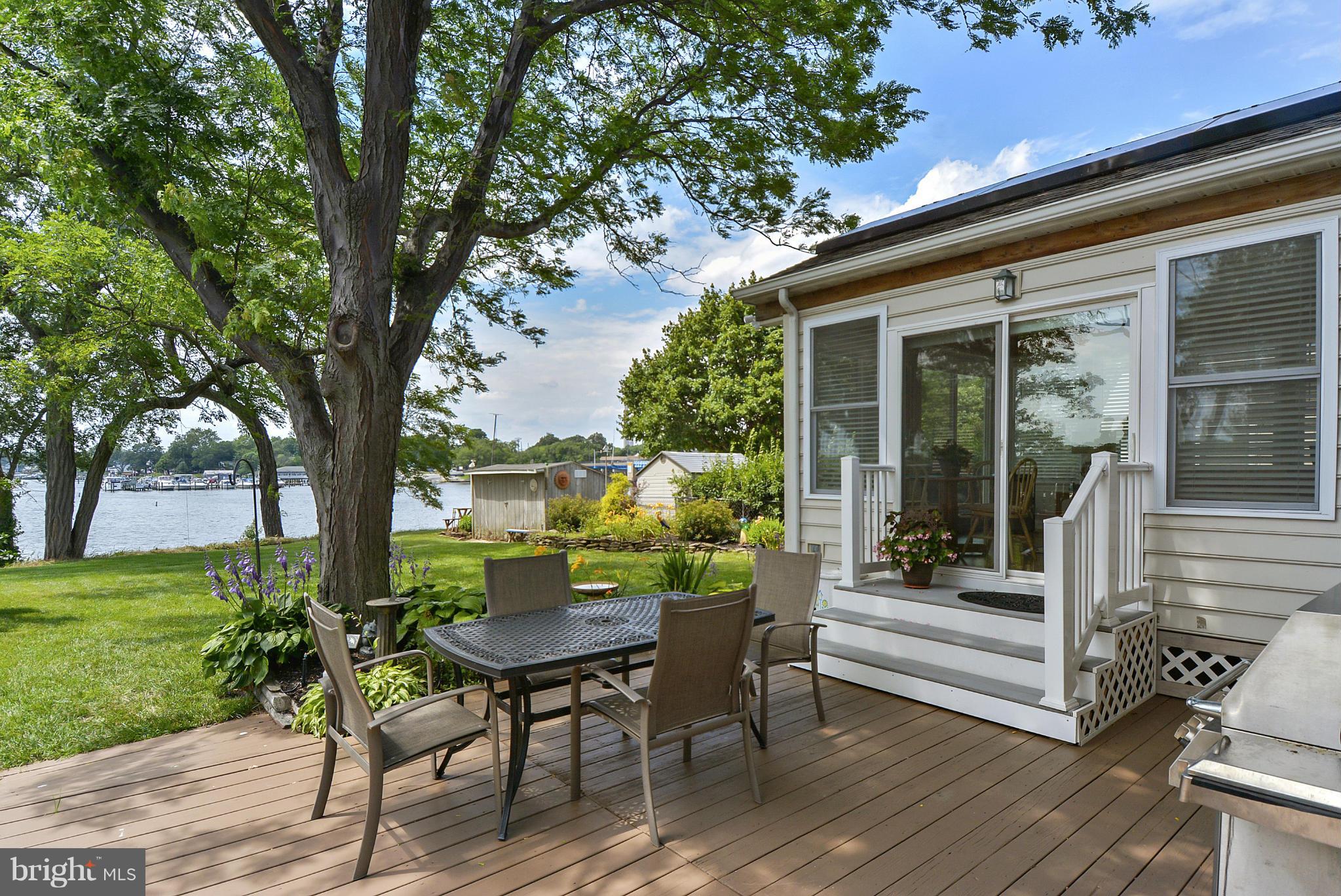 8 Granada Road Pasadena, MD 21122 - Photo 1 of 30 a view of a patio with table and chairs and a large tree