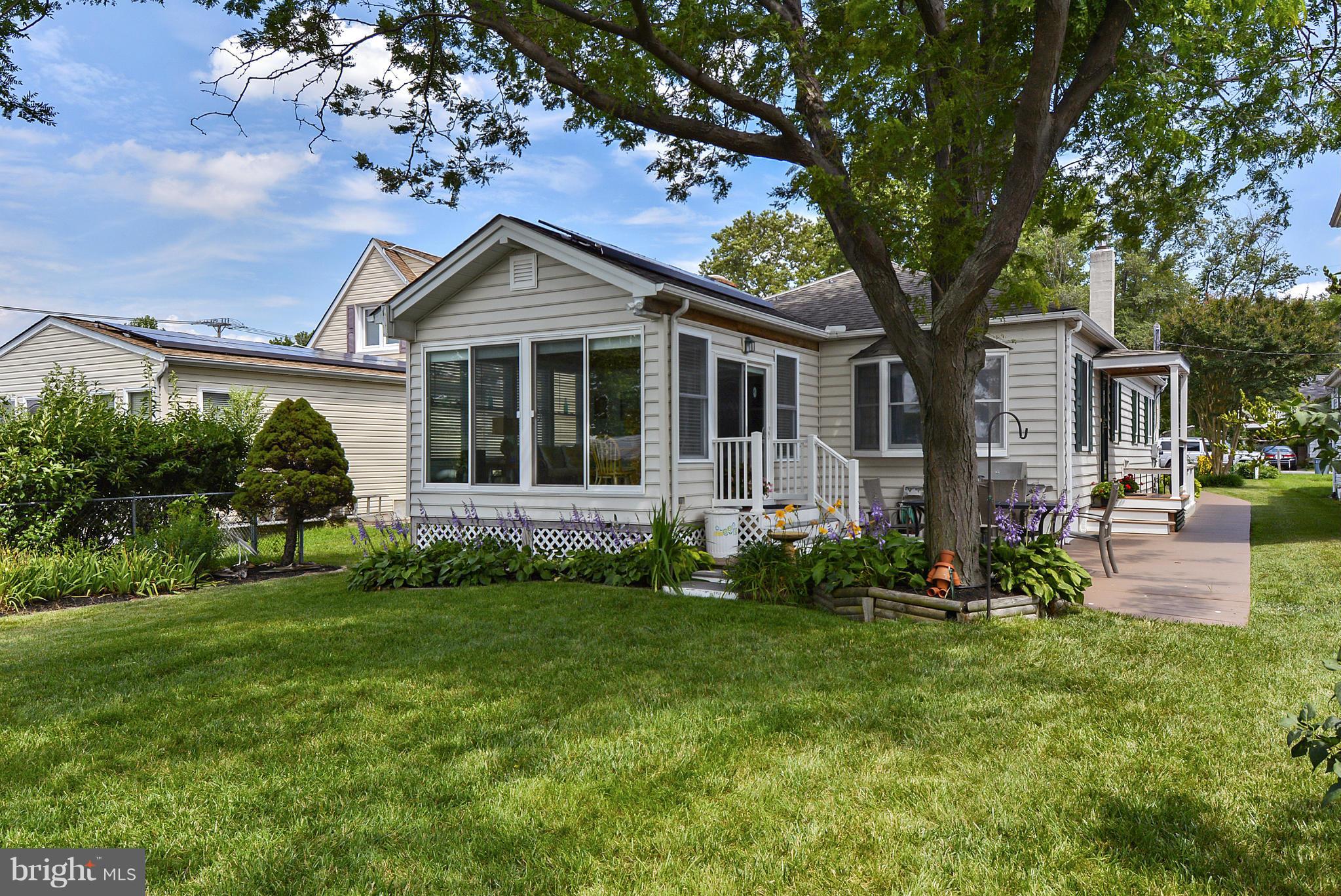 8 Granada Road Pasadena, MD 21122 - Photo 2 of 30 a front view of a house with a garden