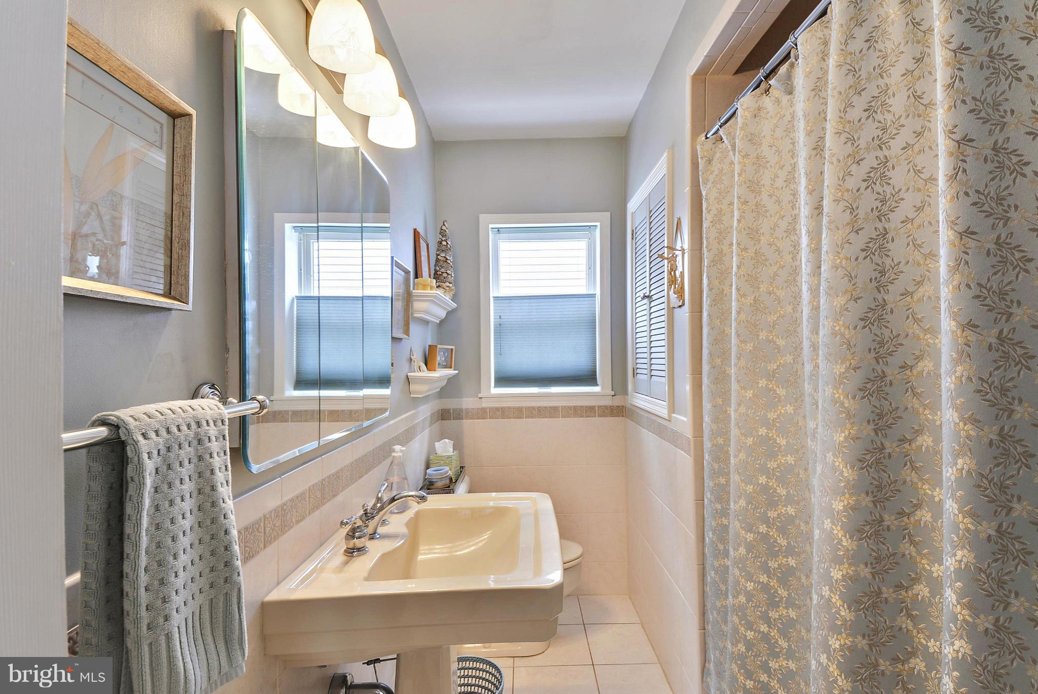 8 Granada Road Pasadena, MD 21122 - Photo 17 of 30 a bathroom with a granite countertop sink and a mirror