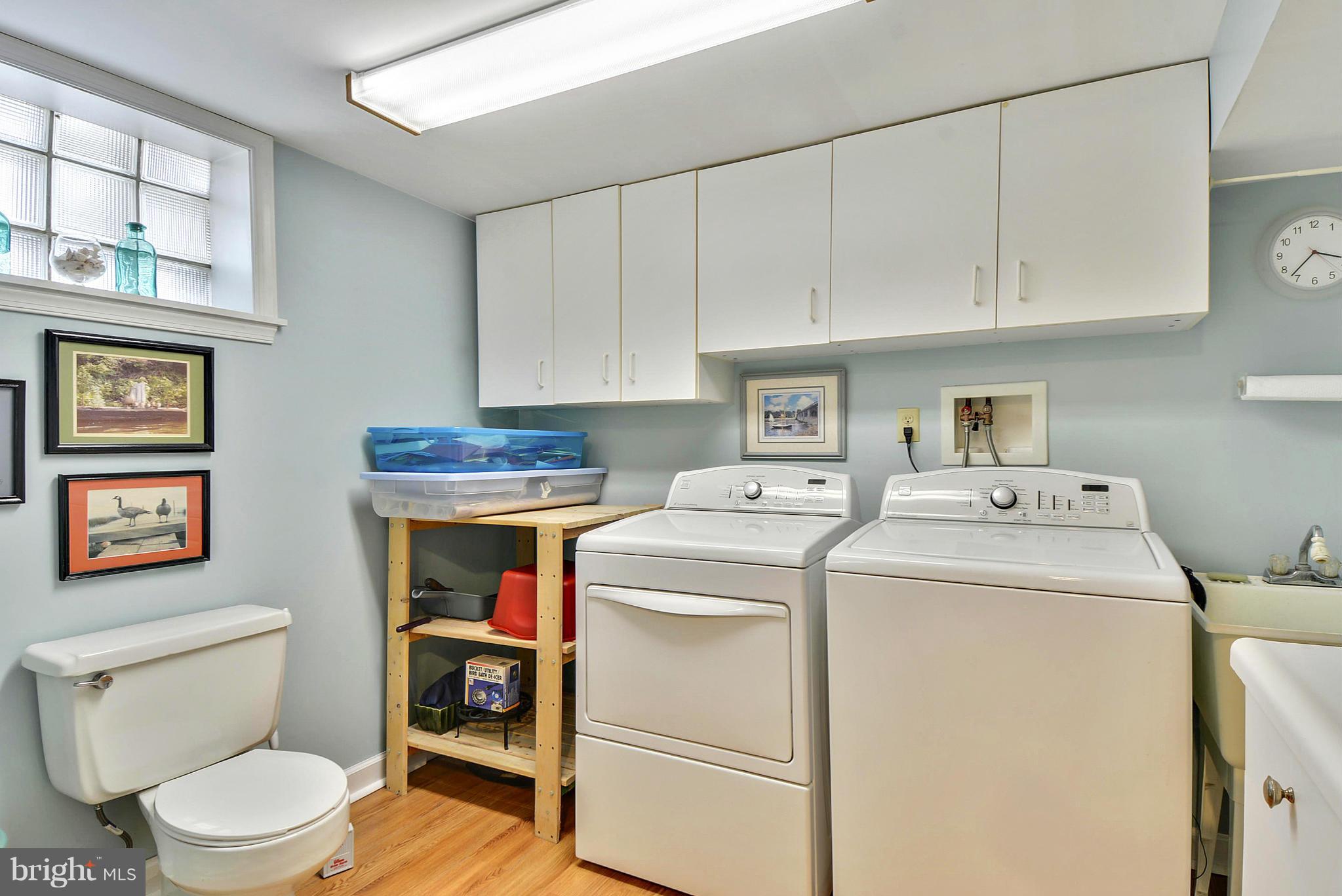 8 Granada Road Pasadena, MD 21122 - Photo 23 of 30 a utility room with dryer washer and a wooden floor