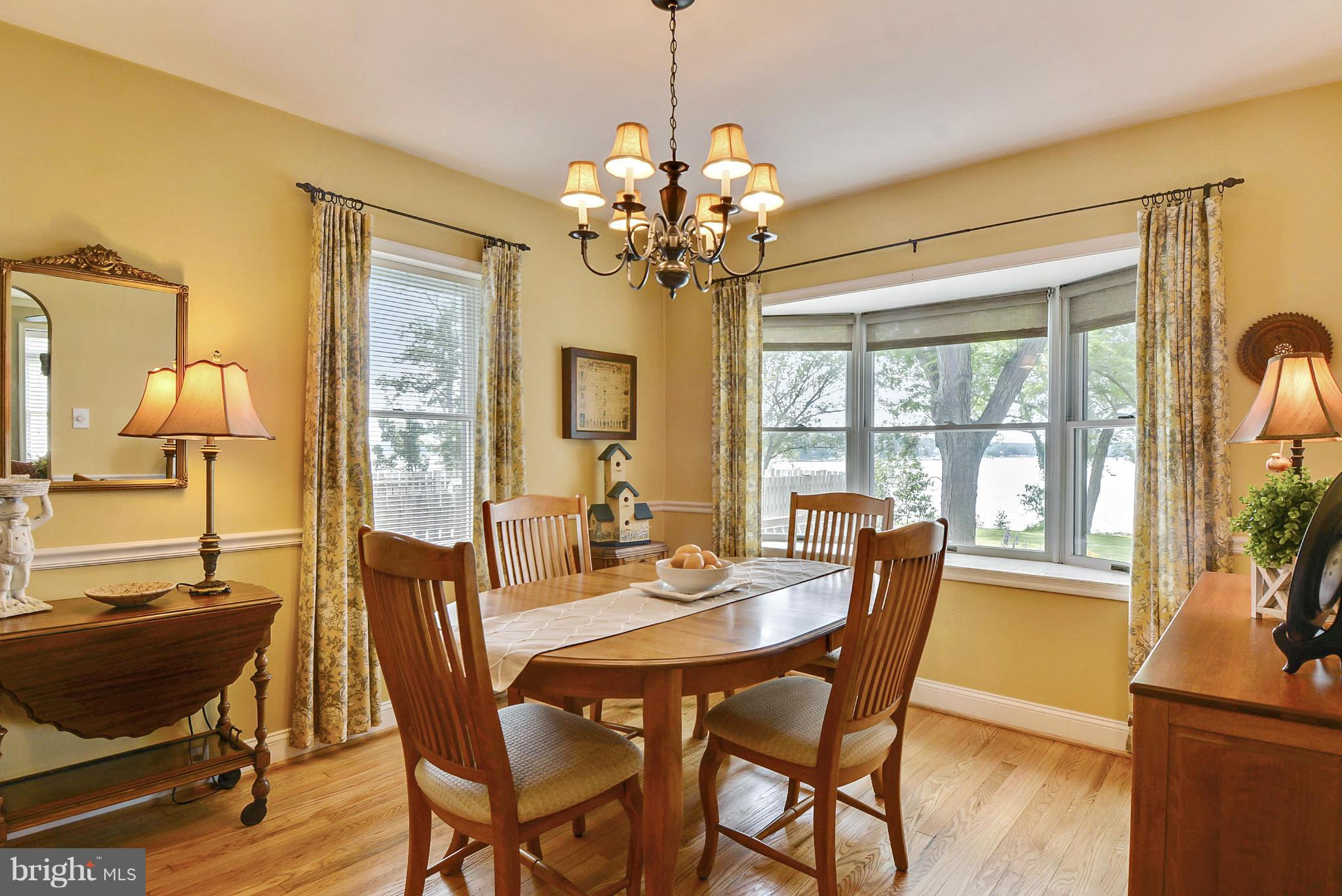 8 Granada Road Pasadena, MD 21122 - Photo 9 of 30 a dining room with furniture a chandelier and wooden floor