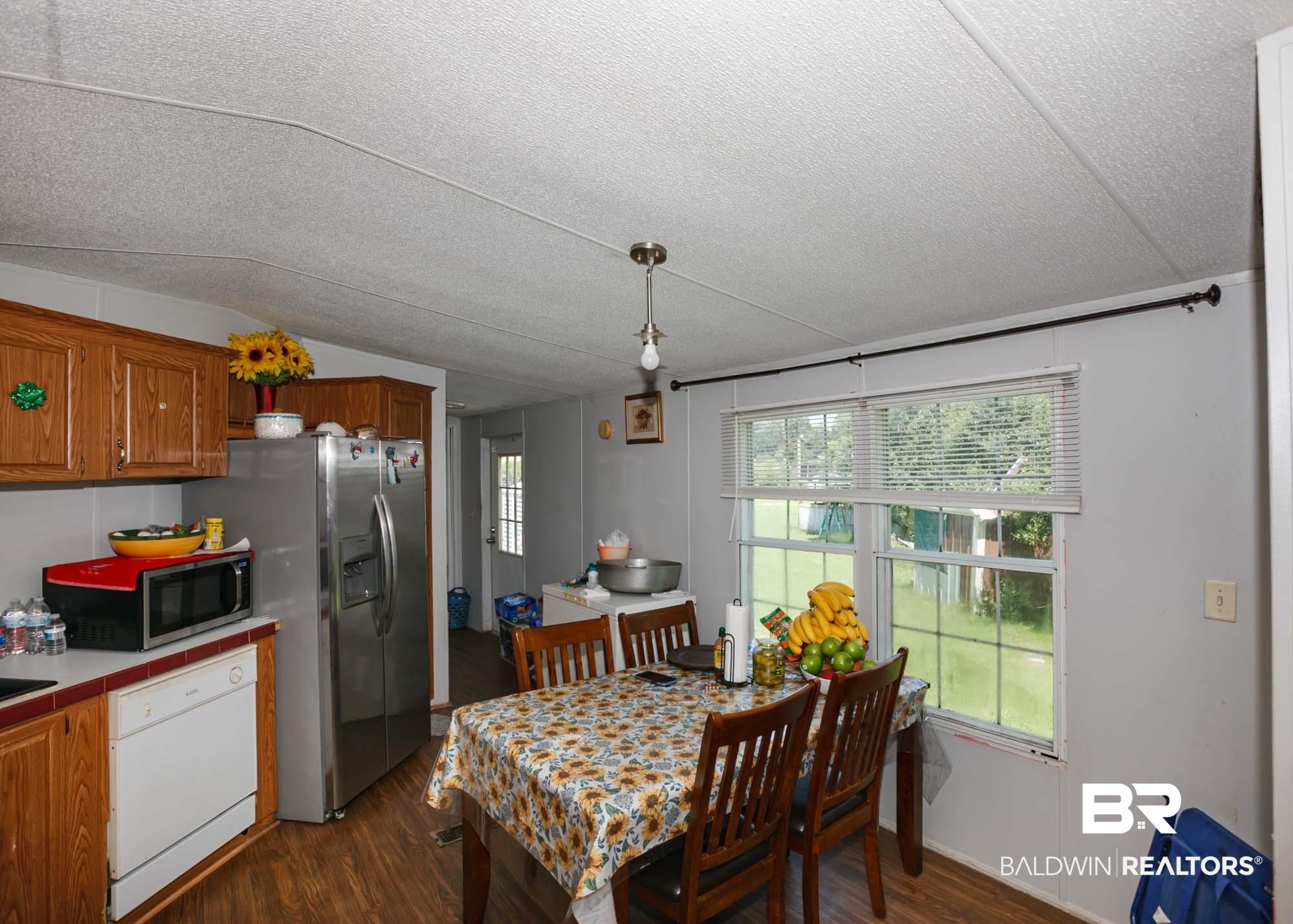 14005 County Road 49 Foley, AL 36535 - Photo 9 of 38 Dining area featuring dark wood-type flooring, a textured ceiling, and healthy amount of natural light