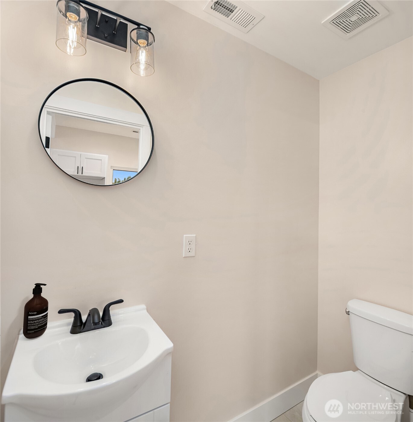 306 3rd Street Sultan, WA 98294 - Photo 17 of 40 a bathroom with a sink a toilet and a mirror