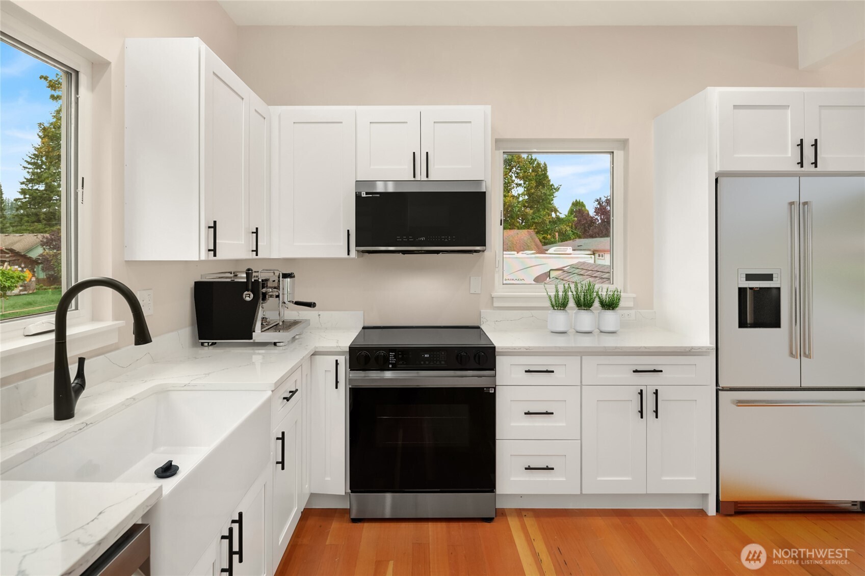 306 3rd Street Sultan, WA 98294 - Photo 9 of 40 a kitchen with stainless steel appliances a stove sink and white cabinets