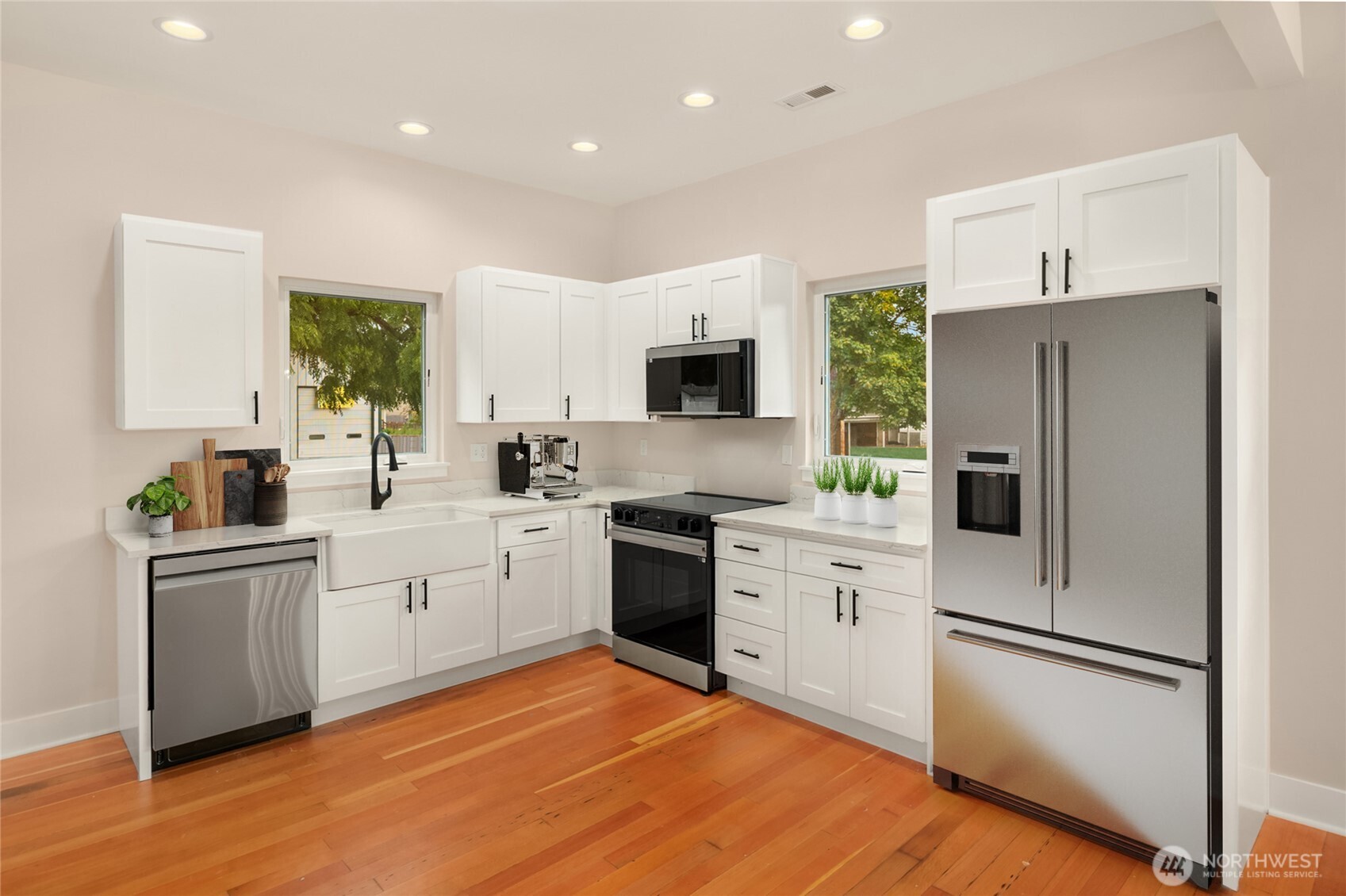 306 3rd Street Sultan, WA 98294 - Photo 10 of 40 a kitchen with white cabinets and white appliances