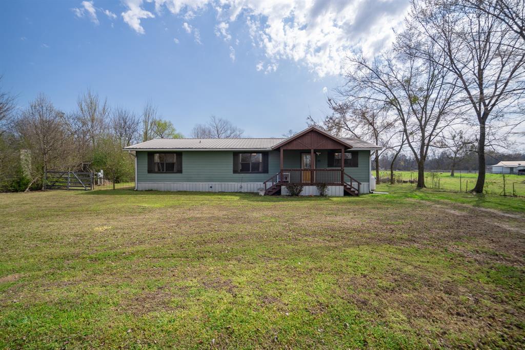 101 Taylor Street Como, TX 75431 - Photo 1 of 39 a front view of a house with garden