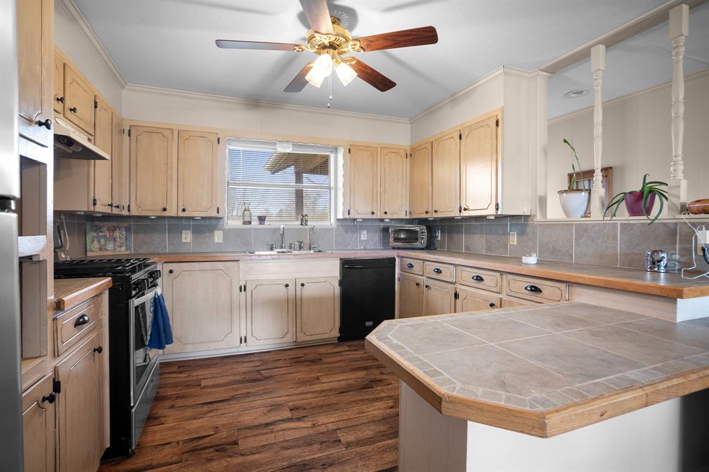 101 Taylor Street Como, TX 75431 - Photo 13 of 39 a kitchen with stainless steel appliances granite countertop a sink a stove and a granite counter tops
