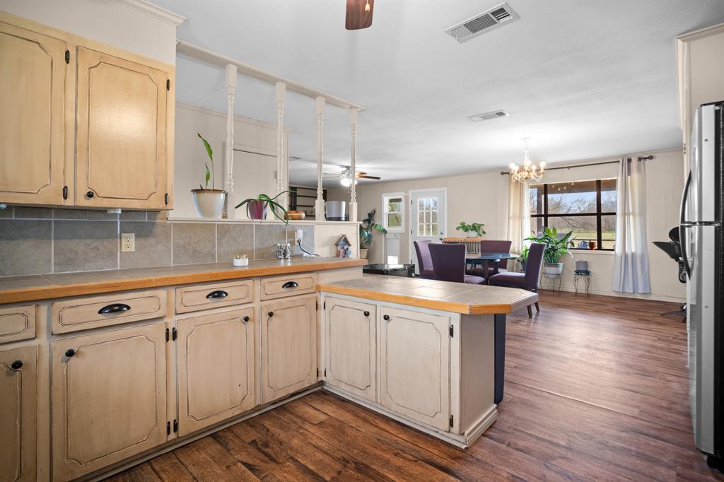 101 Taylor Street Como, TX 75431 - Photo 15 of 39 a kitchen with sink cabinets and wooden floor