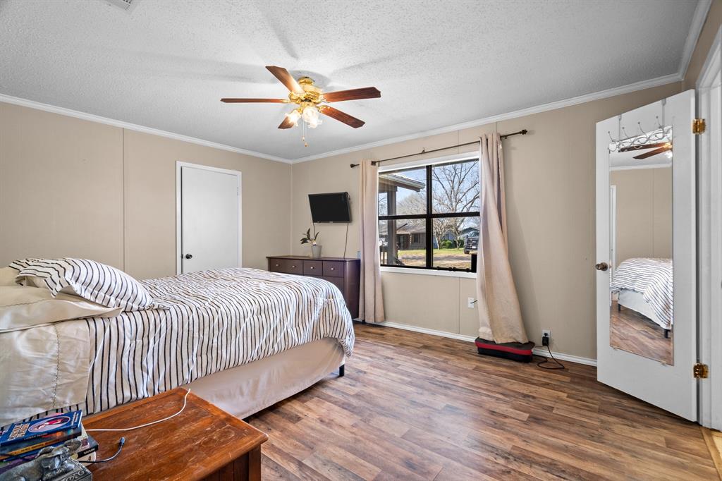 101 Taylor Street Como, TX 75431 - Photo 16 of 39 a spacious bedroom with a bed and a window