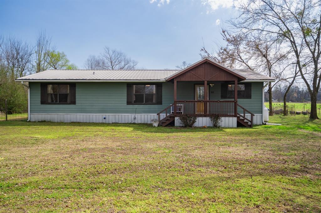 101 Taylor Street Como, TX 75431 - Photo 2 of 39 a front view of a house with garden