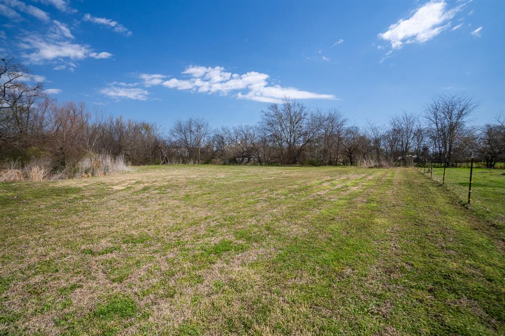 101 Taylor Street Como, TX 75431 - Photo 30 of 39 a view of a grassy field with trees in the background