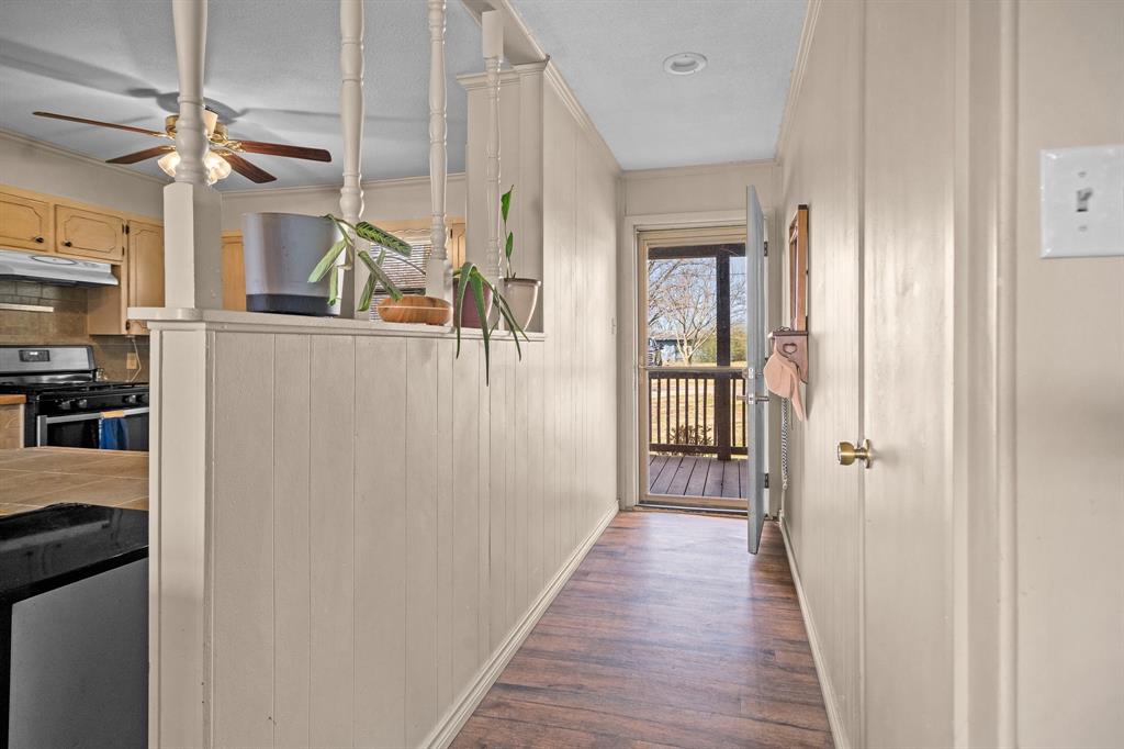 101 Taylor Street Como, TX 75431 - Photo 6 of 39 a view of a hallway with wooden floor and staircase