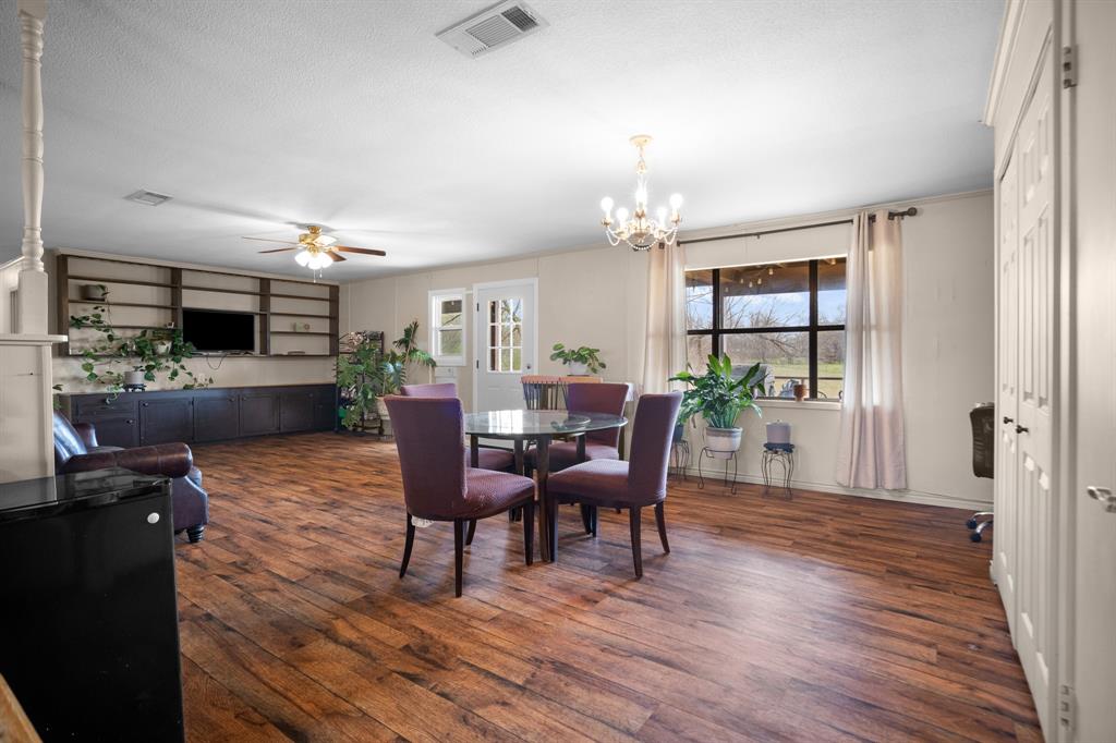 101 Taylor Street Como, TX 75431 - Photo 10 of 39 a view of a dining room with furniture and wooden floor
