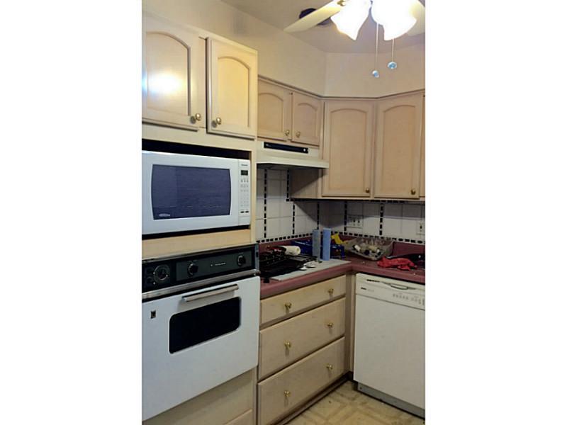 144 North Dithridge Street, Unit 414 Pittsburgh, PA 15213 - Photo 4 of 5 a kitchen with stainless steel appliances granite countertop a stove and a microwave